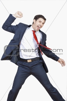 young business executive in suit cheering jumping in the air isplated on white