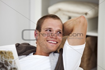 smiling young man reading a book