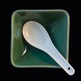 white spoon in green cup