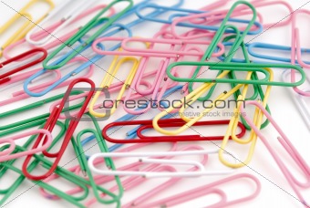 Colored paper clips on white