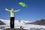 Woman With Green Umbrella In Front Of Melting Glacier