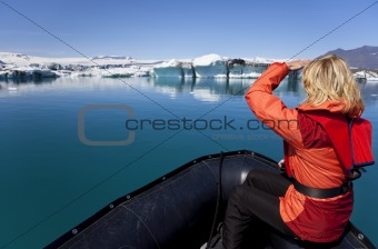 Woman Explorer Using Boat in Iceberg Field, Jokulsarlon Lagoon, 