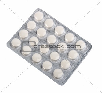 White pills in metallic blister.
