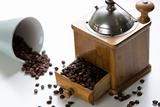 Retro coffee grinder, coffee mug and whole coffee grains isolated on a white background