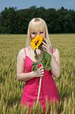 Beautiful blonde girl holding a sunflower