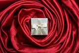 White gift box on red silk
