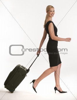 businesswoman traveling with rolling suitcase