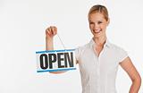 Small business owner holding up Open sign