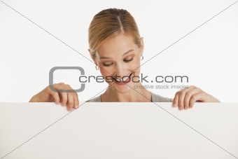 woman holding up blank sign for copy space