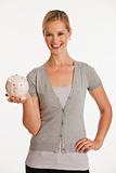 young woman holding up piggy bank