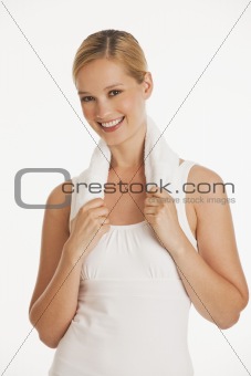 young woman in workout clothes with white towel