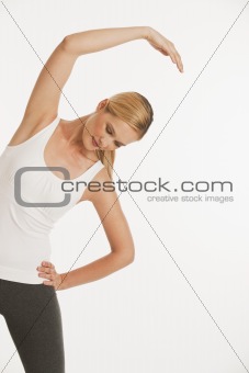 young woman stretching in workout clothes