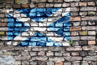 Flag of Scotland on an old brick wall