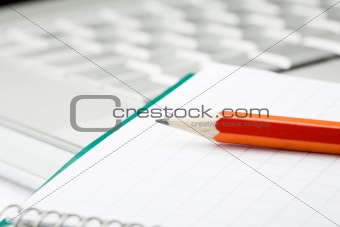 Pencil, notepad and laptop.