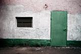 weathered wall with green door