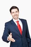 business executive in suit stretching out his hand for handshake - clipping path
