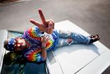 Hippie on the hood of a car