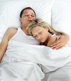 High view of couple sleeping in bed