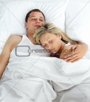 High view of couple sleeping in bed