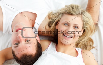Happy couple resting in bed