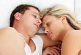 Intimate couple relaxing in bed