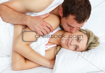 Boyfriend kissing his girlfriend in bed