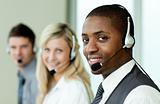 Businesspeople wearing headsets and smiling