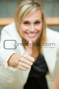 Businesswoman smiling with her thumbs up