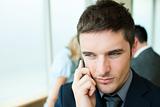 Serious businessman on phone in office