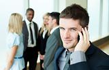 Smiling businessman on phone in office
