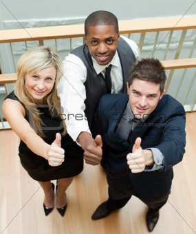 Business people on stairs with thumbs up