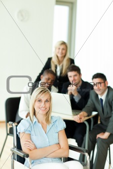 Businesswoman with her group working in the background