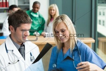 Doctors reading a document in hospital 