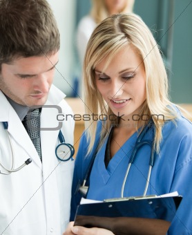Young doctors reading a report