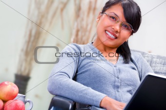 Young woman eith laptop at home