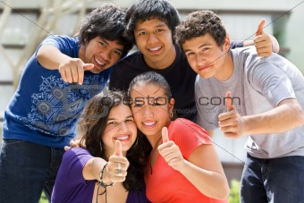 Teenagers posing outside school