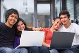 Two couples teenager with laptops at home