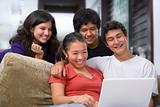 Teenagers watching something on laptop