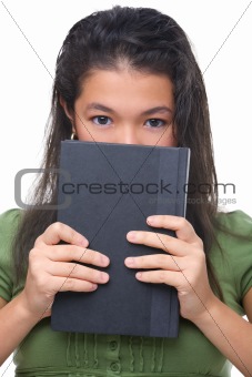 Female teenager hiding hal her face behind book