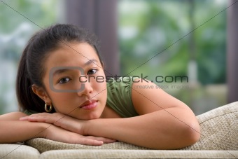 Female teenager on sofa at home