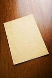 Old blank paper and scroll on wooden table