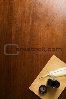 Old paper and quill pen on wooden table