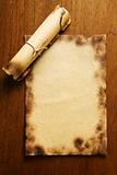 Old blank paper and scroll on wooden table