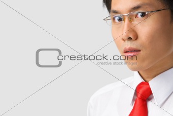 Asian businessman gazing at camera