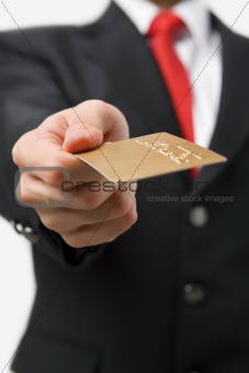 Businessman giving gold credit card