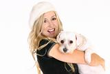 Smiling female holding a dog in her arms