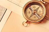Antique brass compass over old map
