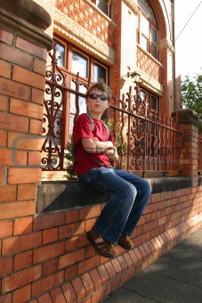 Child sitting on brick wall