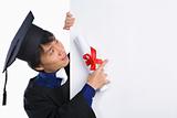 Graduated scholar pointing to white board