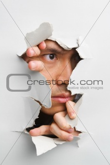 Man looking away from cracked wall